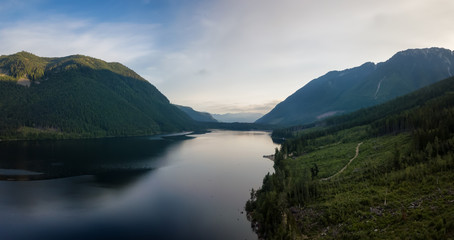 Aerial view of a scenic lake in the Canadian Mountain Landscape during a vibrant summer sunrise. Taken at Jones Lake near Chilliwack and Hope, East of Vancouver, BC, Canada.