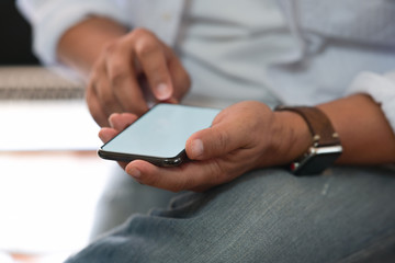 Man sitting while using the mobile smartphone