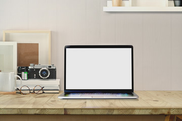 Stylish workspace with blank screen laptop
