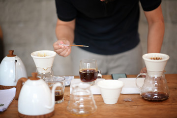 Barista making drip coffee and accessories on the table