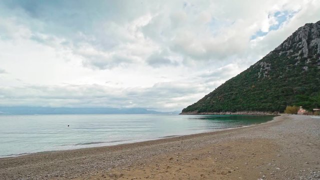Beautiful landscape of Divna beach and its calm waters at a cloudy day. Cres Island. Croatia. Flat plane