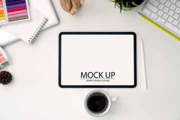 Mock up blank screen tablet on creative designer workspace