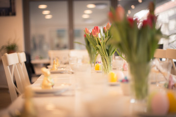 Ostergedeck auf einem Tisch mit Tulpen