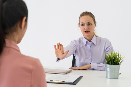Two young business women in meeting at office table for job application and business agreement. Recruitment and human resources concept.