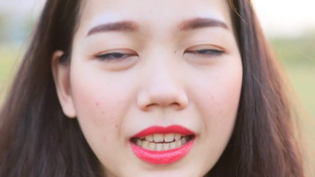 close up face of younger asian woman funny face