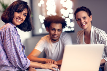 Teamwork concept.Young creative coworkers working with new startup project in modern office.Group of people analyze data on desktop computer.