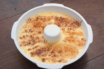 home made vanilla and cinnamon flan over a wooden table