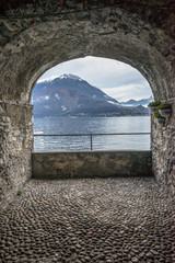 Italy, Varenna, Lake Como, SCENIC VIEW OF SEA SEEN THROUGH ARCH WINDOW
