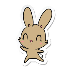 Obraz na płótnie Canvas sticker of a cute cartoon rabbit dancing