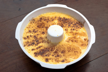 home made vanilla and cinnamon flan over a wooden table