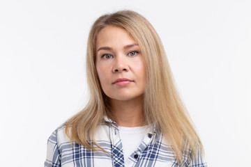 Naklejka premium Fashion, style and people concept - portrait of pretty young blonre woman over white background