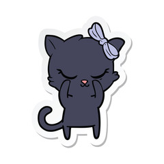 sticker of a cute cartoon cat with bow