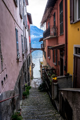 Fototapeta na wymiar Italy, Varenna, Lake Como, a narrow street in front of a brick building