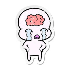 distressed sticker of a cartoon big brain alien crying