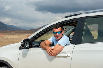 Man in vehicle, looking out of window