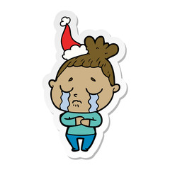 sticker cartoon of a crying woman wearing santa hat