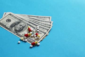 Various medicines and pills on background of USA dollars banknotes