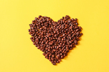 Roasted coffee grains lying in the shape of the heart