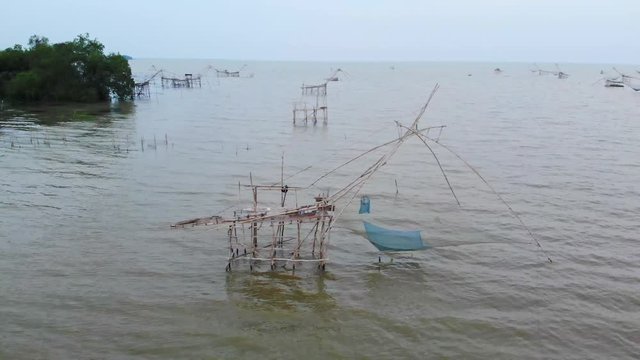aerial movie Traditional Local Fishing Trap also Known as Yor Building at Pakpra Phatthalung Thailand.