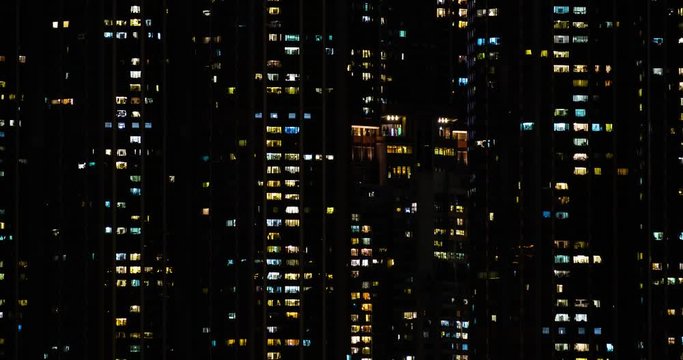 Time lapse of apartment building at night. Turns on and off the light in the windows. 4K. 