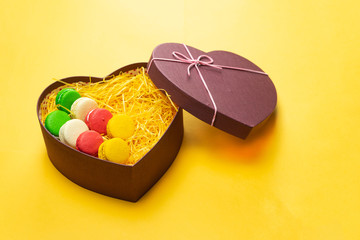 Macaroons in a gift box. Heart-shaped box. Copy space.