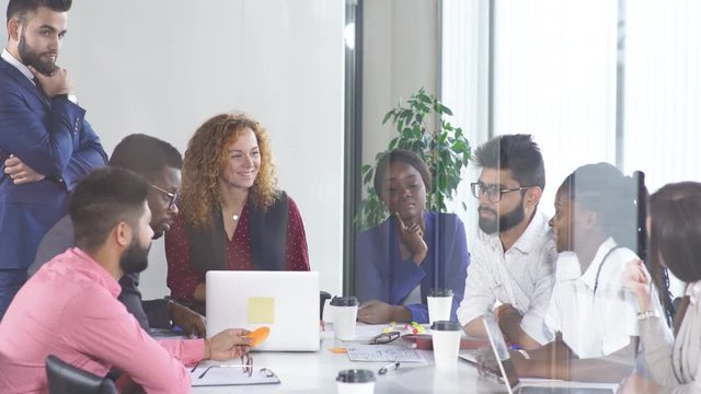 Multiracial, business people talking in break, communicate and have consultation with the application form in hand over panoramic windows.