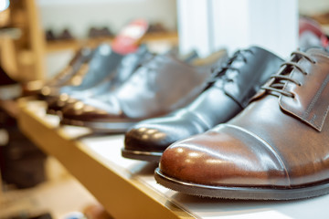 a row of leather brown men's shoes in the store 