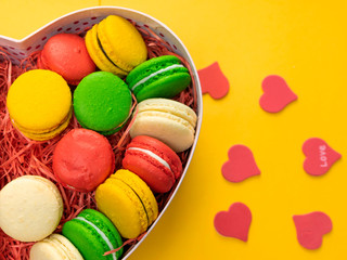 Macaroons in a gift box. Heart-shaped box. Copy space.