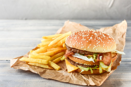 burger and  fries. take away lunch, fast food restaurant, fast food menu.pink background, selective focus and copy space. 