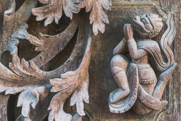 Archaeological, Close Up of carved art figures on old wood carvings on the wall temple at Shwe Nan...