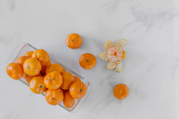 Fresh orange fruit on white marble background.