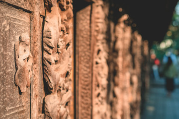 Archaeological, Close Up of carved art figures on old wood carvings on the wall temple at Shwe Nan Daw Kyaung (Golden Palace Monastery) in Mandalay, Myanmar