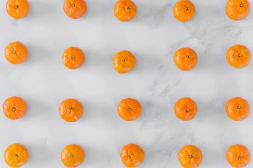 Fresh orange fruit on white marble background.
