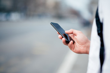 Using smartphone at the city street.