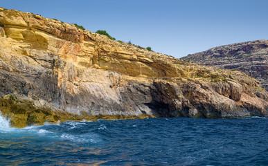 Fototapeta na wymiar Yellow rocks of coast of Malta island in Mediterranean sea.