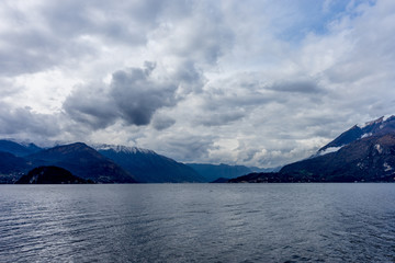 Italy, Varenna, Lake Como, a large body of water with a mountain in the background