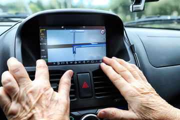 Close up woman hand press navigation screen in the car