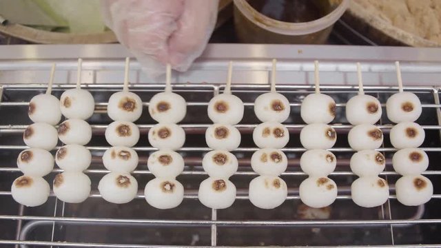 Making Dessert Mitarashi Dango Stick on Hot Stove, Street Food of Japan Traditional 