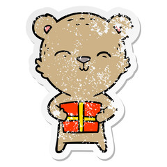distressed sticker of a happy cartoon bear with gift