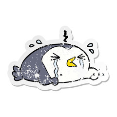distressed sticker of a cartoon crying penguin