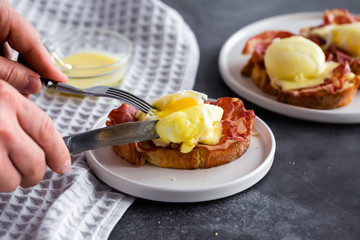 Bruschetta with parma ham and Egg Benedict. Classic Eggs Benedict with bacon, hollandaise sauce,...