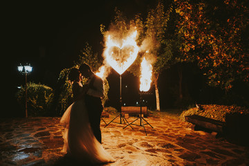 bride and groom on background of fire