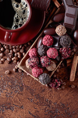 Various chocolates  and cup of black coffee.
