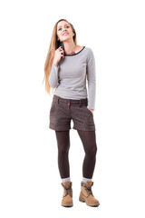 Happy young woman put call on hold pausing and holding cellphone under ear. Full body isolated on white background. 