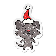 distressed sticker cartoon of a dog wearing santa hat
