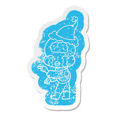 cartoon distressed sticker of a big brain alien crying and pointing wearing santa hat