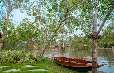 Fototapeta na wymiar Rowboat on the brae beside of Canal with Thai lifestyle, Countryside of Thailand
