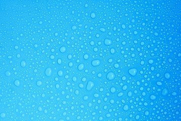Naklejka na ściany i meble closeup drops water on blue background
