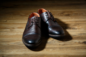 Brown men's shoes are on the floor