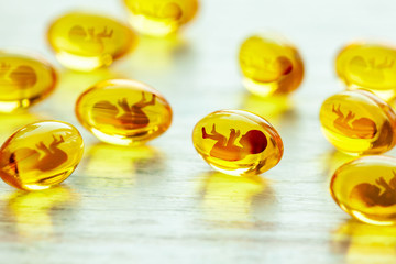 Artificial insemination. Pregnancy pills, yellow pills with baby silhouette. Baby test tube, IVF...